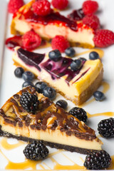 Cheesecake. Traditional Classic New York Style cheesecake dessert topped with fresh starwberry and a a strawberry sauce. A bakery or pastry shop favorite. 
