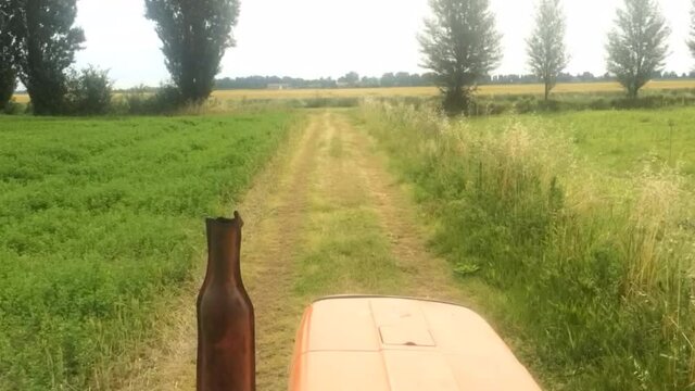 The tractor rides on the field view from the cabin, time lapse