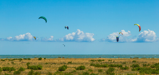kite-surfing on the beach under a beautiful sky