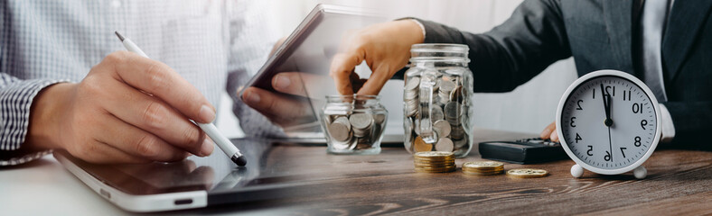 businesswoman holding coins putting in glass with using smartphone and calculator to calculate concept saving money for finance accounting
