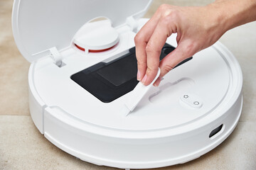 Repair robot vacuum cleaner, closeup. Household appliance service
