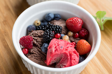 Ice cream with fruit in a white bowl. Summer dessert.