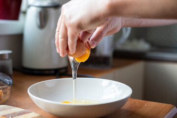 Egg broken into a bowl. Preparation of ingredients for breading.
