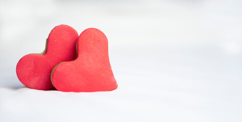 Fototapeta premium Two heart shaped cookies on white soft background .Valentines day greeting card . Chrictmas and winter romantic Winter Concept.