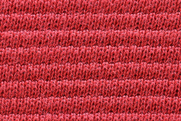 Texture of red cotton fabric, close-up.