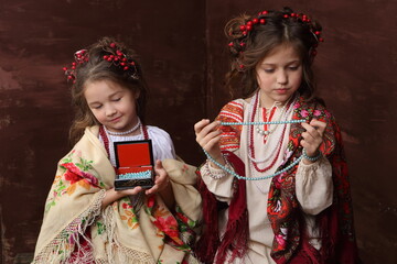 Two girls trying on beads
