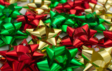Red, green, golden bows, close-up. Packing presents for Valentine's day, flat lay