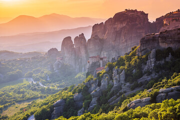 Meteora, Greece. Sandstone rock formations, the Rousanou, the Nikolaos and the Grand Meteora monasteries at sunset.