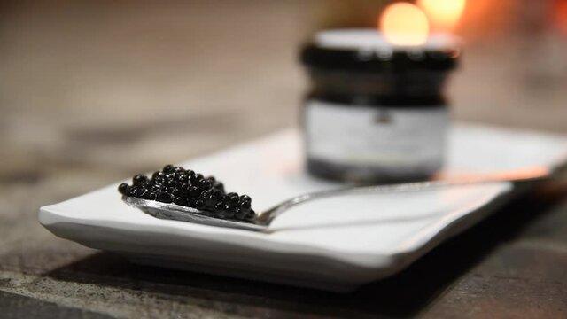 Attilus Caviar Royal Siberian Caviar. A tablespoon of caviar. Some caviar gnaws on a plate. Detail shot of caviar gnaws. Detail shot of Siberian caviar