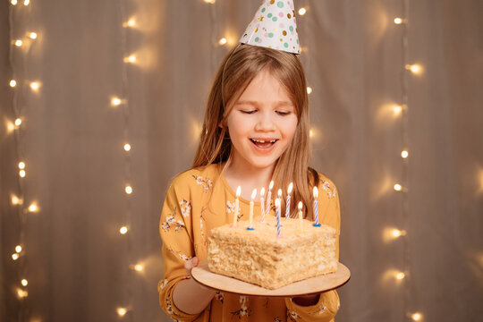 Beautiful Happy Girl With Birthday Cake. Tradition To Make A Wish And Blow Out The Fire At The Party. Holiday.