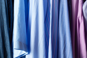 Close up of many shirts on hangers. Shopping concept