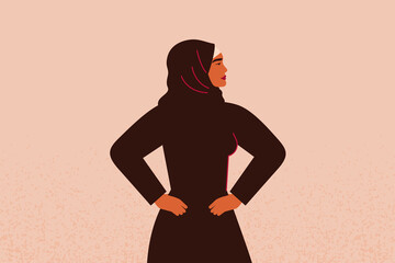 Young strong muslim female with hands on her hips looks forward. Confident Arabian Businesswoman or entrepreneur in abaya. Concept of gender equality and of the female empowerment movement.