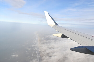 Fototapeta na wymiar Beautiful white clouds floating high angle air, viewed from airplane window.