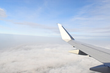 Fototapeta premium Beautiful white clouds floating high angle air, viewed from airplane window.