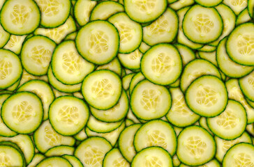 Cucumber slices covering screen background. Food concept theme