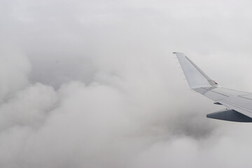 Beautiful white clouds floating high angle air, viewed from airplane window.