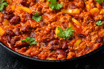 Vegetarian vegan mince chili con carne served in cast iron skillet pan