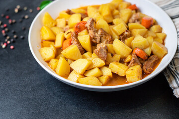 goulash with potatoes and meat stewed vegetables and pork ready to eat on the table for healthy...