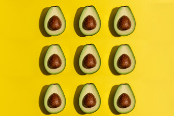 Multiple avocados on yellow background