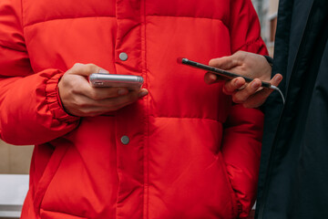 hands of young people with mobile phones on the street