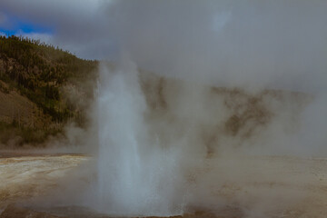 close up of hot blasting water from active gushing gayser in yellowstone national park in america