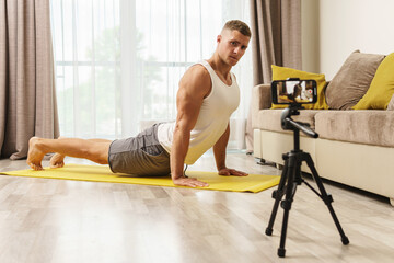 Fitness blogger streaming or recording video for his subscribers