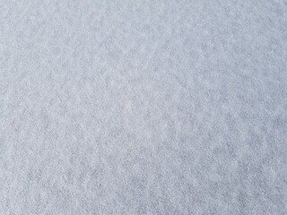 Frozen Snow on Ice Bumpy Texture. A thin layer of snow frozen onto the ice on a cold winter day.