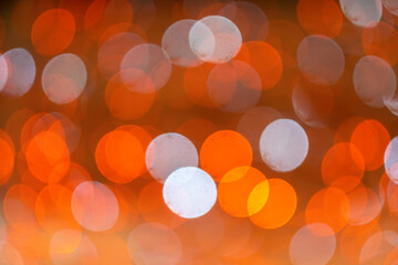 Abstract bokeh lighting background. Festive abstract orange background with bokeh defocused lights.