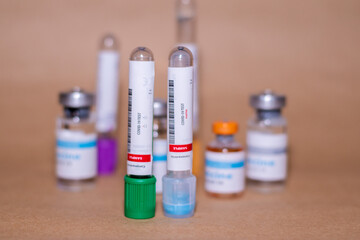 Testing for presence of coronavirus. Tube containing a swab sample that has tested positive for COVID-19.