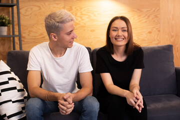 Young happy couple is sitting with a psychologist. Young couple is happy