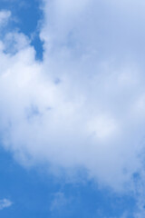 White clouds in the blue sky as a background.