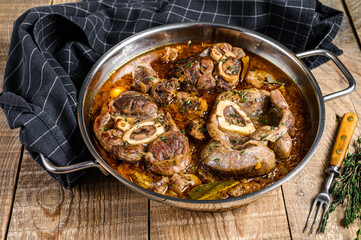 Stewed veal shank meat Osso Buco,  italian ossobuco steak. wooden background. Top view - obrazy, fototapety, plakaty