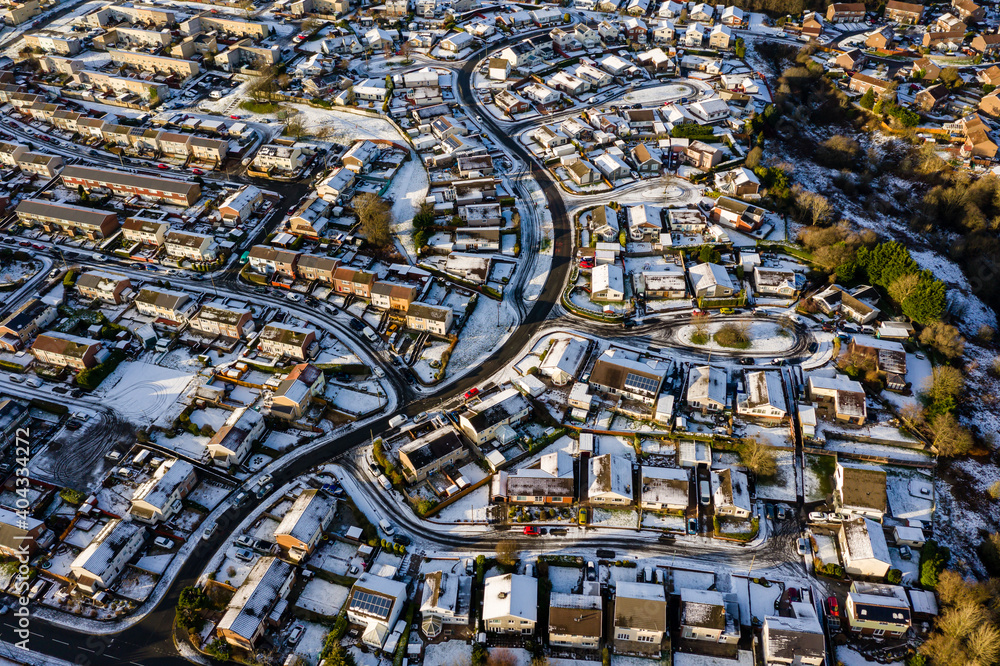 Wall mural aerial view of a snow covered town on a bright, sunny winters day - Wall murals