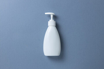 White bottle with hand soap, shower gel or body cream on gray background, mock up with place for text or copy space. Personal hygiene, skin care concept. Horizontal. Minimal style. Flat lay, top view