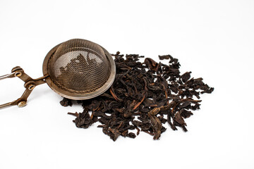 Handful of black tea leaves on white background, The drink is indispensable when you need to warm up, but it is also excellent in the heat.
