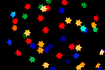 Colorful stars abstract background. Glowing stars lights on black background