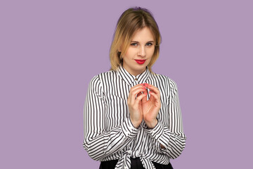 Scheming sly woman with beautiful red lips in striped blouse smirking at camera, thinking over...
