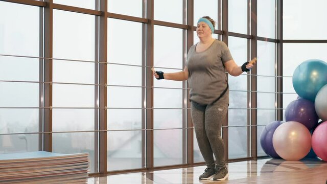 Middle-aged woman wants to lose weight. She is working hard at a gym and train.