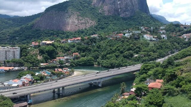 Aerial drone image showing a bridge located between jo&aacute; and barra da tijuca with a stunning view of Rio de Janeiro. Cars traveling the route