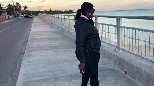 Old Bahama Mama OBM at Sea wall in Black Outfit. Freeport, Bahamas  