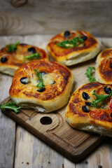 Soft focus. Homemade mini pizzas on a wooden board. Healthy food.