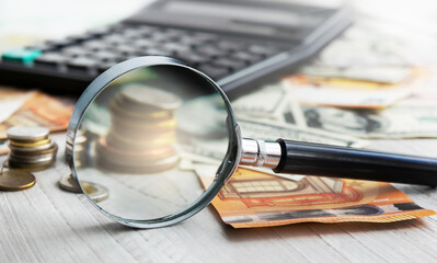 Calculator and magnifying glass. Office equipment at workplace. Conceptual image of desk work, financial paperwork and business economy.