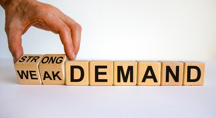 Strong or weak demand symbol. Businessman hand turns cubes and changes words 'weak demand' to 'strong demand'. Beautiful white background. Business and strong demand concept. Copy space.