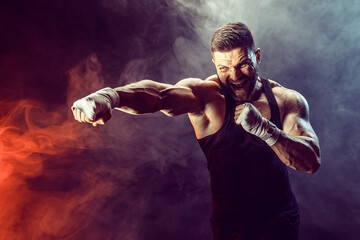 Sportsman boxer fighting on black background with shadow. Copy Space. Boxing sport concept. Smoke...