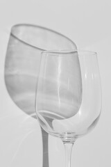 A part of wine glass lies on white background. 