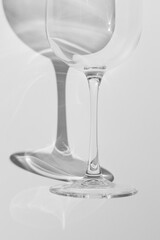 A part of wine glass lies on white background. 