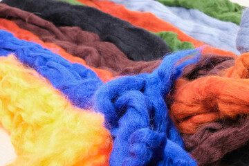 wool of different colors and textures. Background made of wool felting in the form of lines.