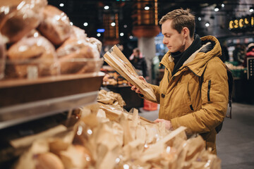 Man choice bread in the supermarket
