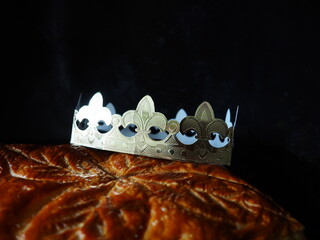 Closeup on the crown on top of an Epiphany cake, or Kings cake, traditional puff pastry french...