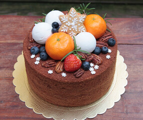 Russian chocolate cake "Medovik" with fresh fruits, nuts, and handmade gingerbread